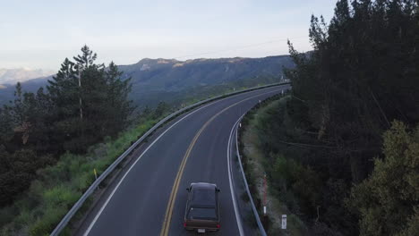 iconic california road, vehicle driving on scenic mountain road, aerial view