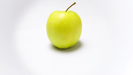 camera moving around one yellow apple