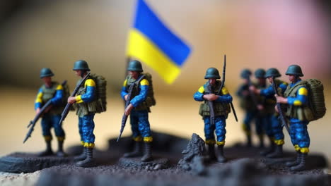 ukraine miniature toy soldiers army and ukrainian flag in war scene illustration, macro tilt-shift of battle concept