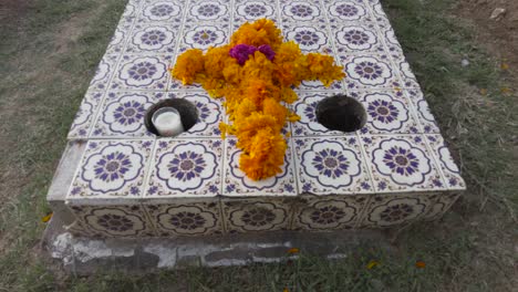 tilt up shot of a tomb adorned with cempasuchil marigold flowers for the celebration of the day of the dead at a graveyard in mexico puebla cholula