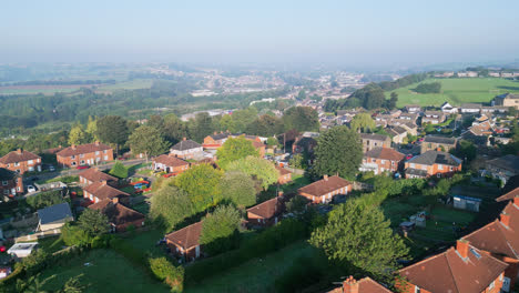 A drone&#039;s perspective on Dewsbury Moore Council estate, UK, with red-brick houses and the Yorkshire industrial scene on a sunny morning