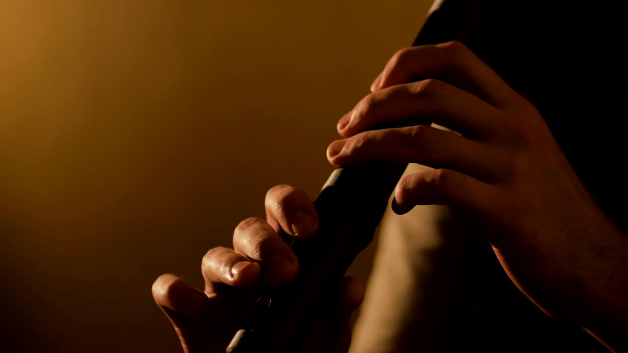 Man playing japanese bamboo flute - shakuhachi