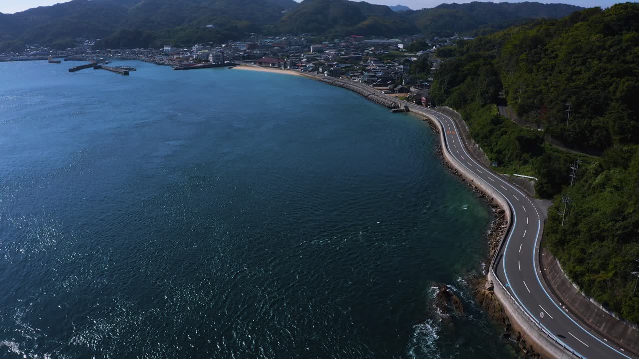 Aerial View of Coastal Road Winding Through Japanese Town