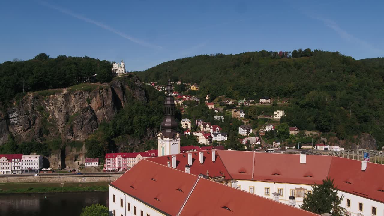 Drone ascending over Decin Castle and Shepherd's Wall with early morning light and clear sky