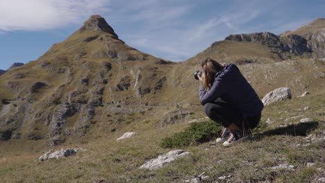 photographer taking pictures of limestone massif in durmitor national park in montenegro. - wide shot