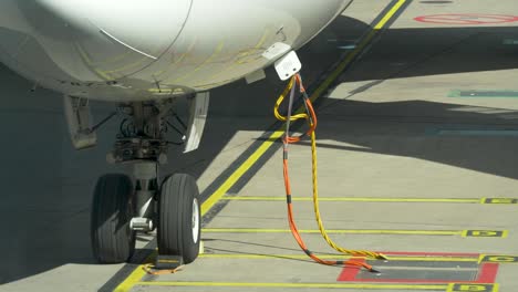 close-up of cables connected to an airplane during maintenance