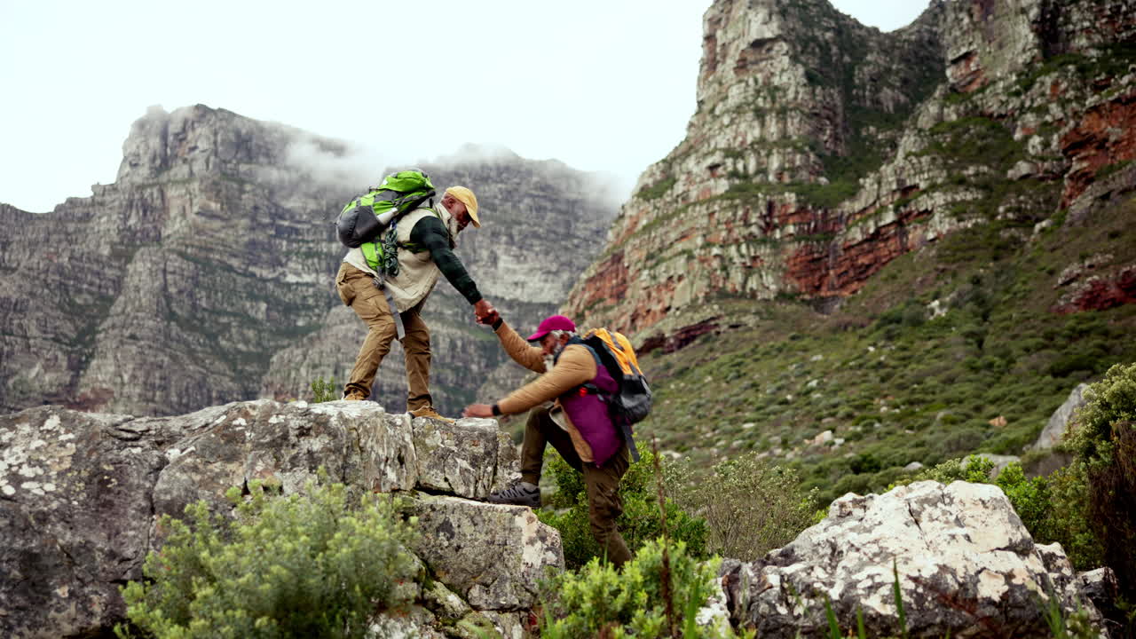 Senior men hiking together in the mountains
