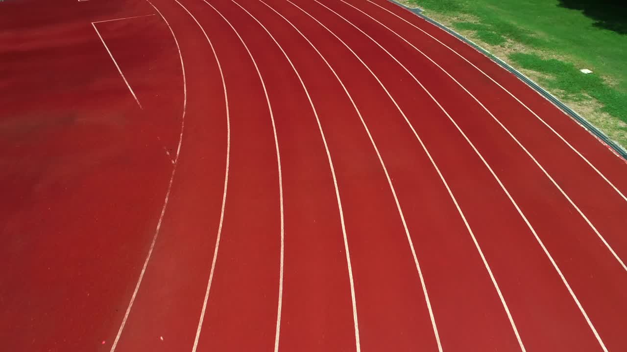 スタジアムの陸上トラック。色はオレンジ色のレンガ、ドローンによる高アングルからの眺め