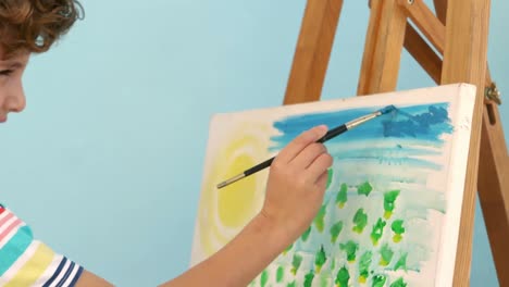Smiling-boy-painting-his-picture