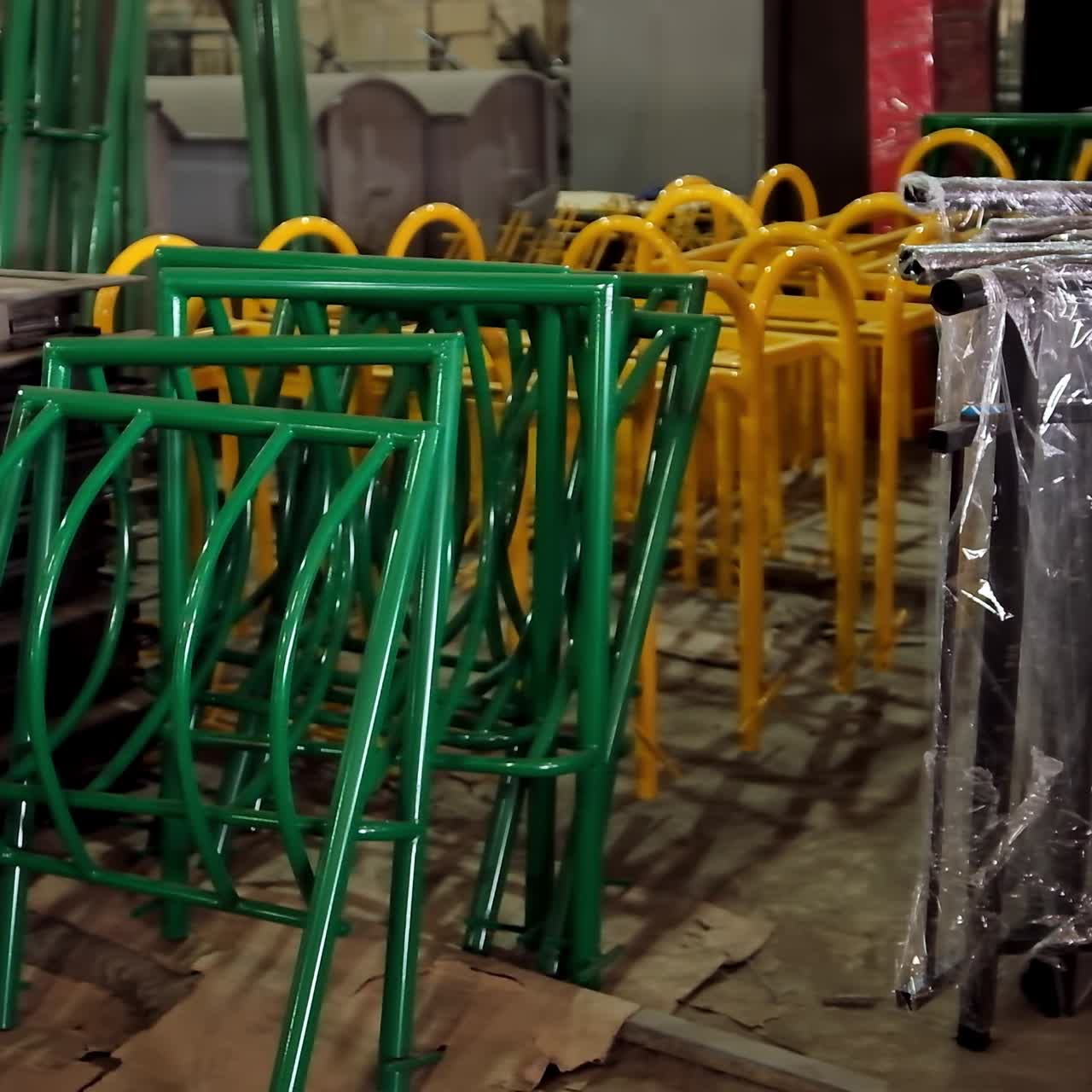 Metal construction parts. Colorful equipment for fence inside the warehouse. Disassembled parts of fence.