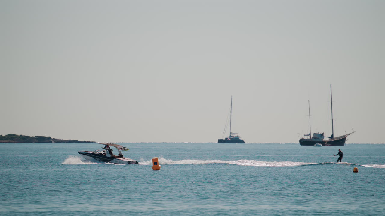 Cannes, France - October 7, 2025: A sleek speedboat glides across the calm blue waters on a sunny day, leaving a gentle wake behind