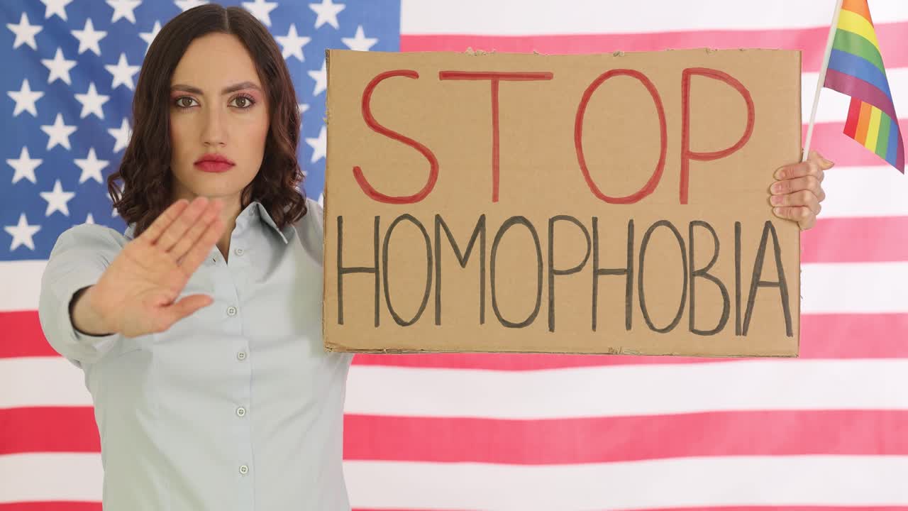 Woman Protesting Homophobia with American and Rainbow Flags