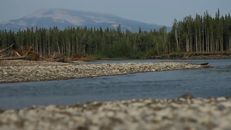 River-from-riverbank-pebbles-and-peak-in-background