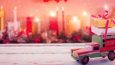 model car with presents on its roof and blurred background of candles combined with falling snow