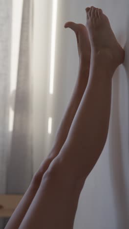 woman's legs up against a wall