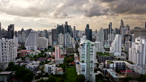 aerial tracking view of bangkok city skyline under impressive sunset sky