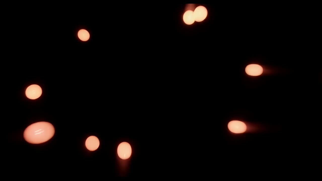 Orbiting orange orbs with trails converging to center on black field, looping into heart with core