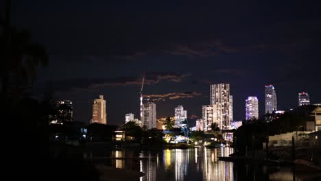 timelapse of illuminated city skyline and water reflections