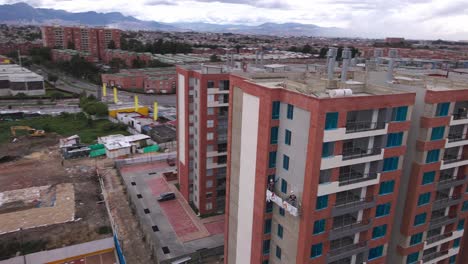 group-of-workers-diligently-applying-cement-to-the-exterior-wall-at-a-construction-site,-showcasing-their-expertise-and-dedication-to-the-project