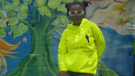 Amazing-young-dancer-enjoying-her-choreography-in-this-urban-setting-with-wall-art-in-the-background