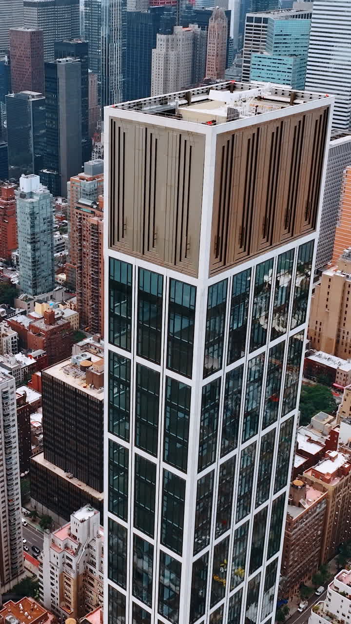 Sutton Tower building in the architecture of New York. Top view on the luxurious skyscraper at the backdrop of cityscape. Vertical video