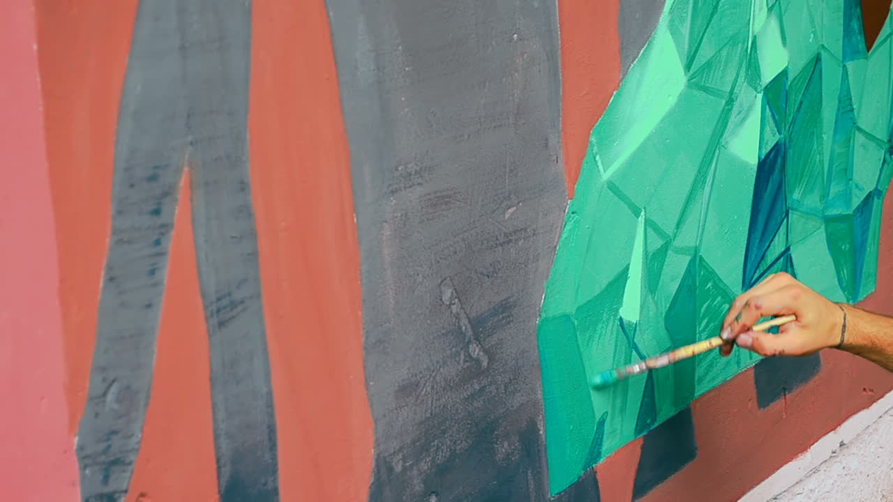 L'artista disegna graffiti su una recinzione. Disegno astratto