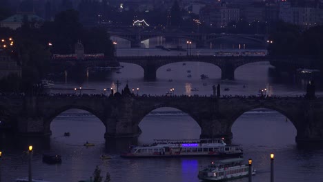 beautiful night establishing shot of boats along the vltava river in prague czech republic 1