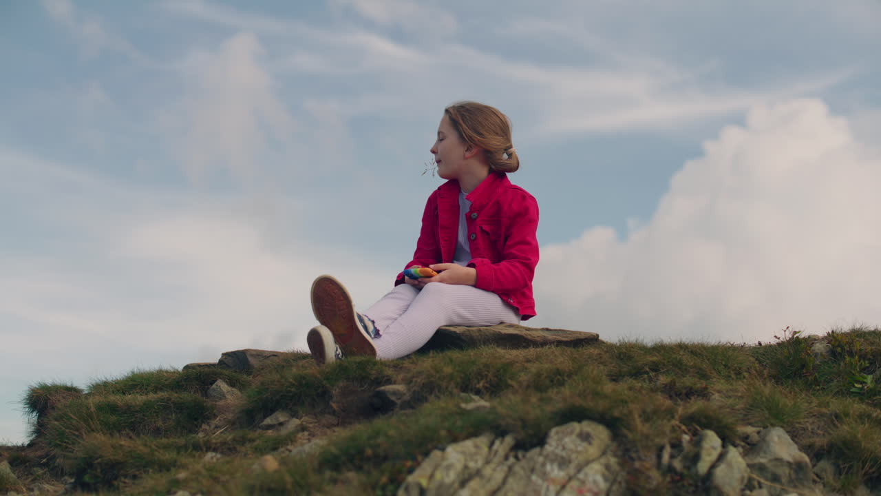 Portrait of a Young Girl Sitting on a Wickerwork in the Field Portrait of a Young Girl from the Countryside in a White Skirt and Shirt Sitting on a Wickerwork in the Field and Eating an Apple Lonely Girl Picnic in the Field