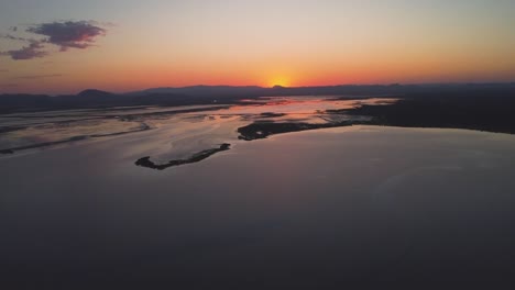 drone overflies beach at sunrise