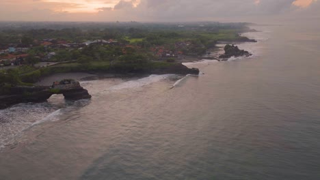 gorgeous rocky coastline of tabanan, bali at sunset - aerial drone view