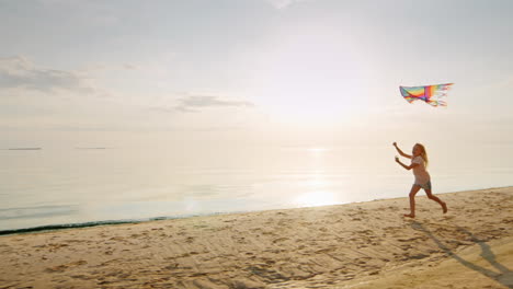 happy little blond girl is running with a kite on the seashore at sunset concept - childhood dreams