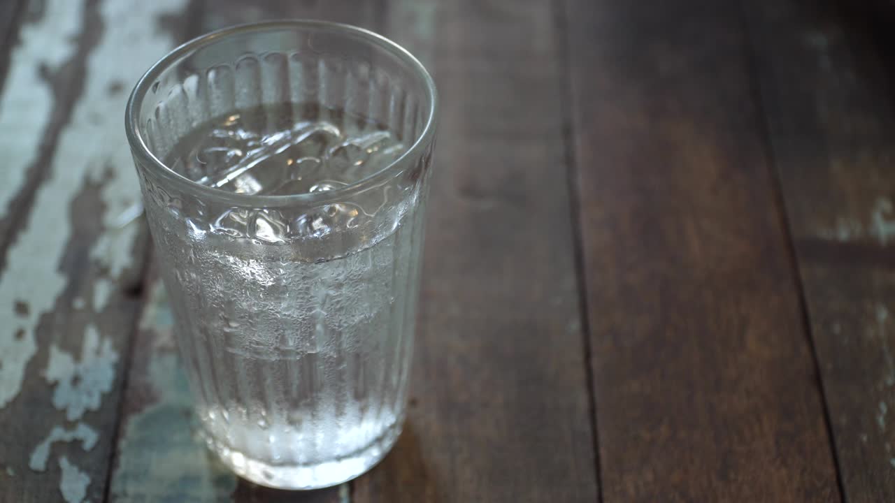 식당의 테이블 위에 있는 유리잔에 물을 부어 넣는 것.