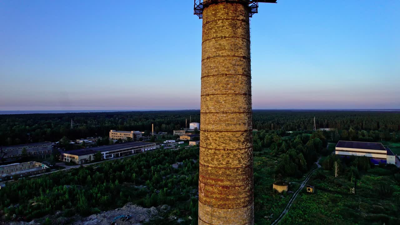 Historic chimney tower stands tall in aerial view over Latvia landscape