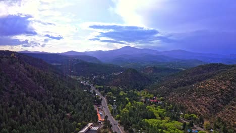 Forested-mountains-with-asphalt-road-going-through