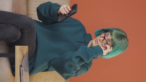 Vertical-video-of-The-young-woman-wearing-glasses.