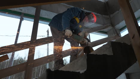 construction worker cutting metal pipe on a construction site