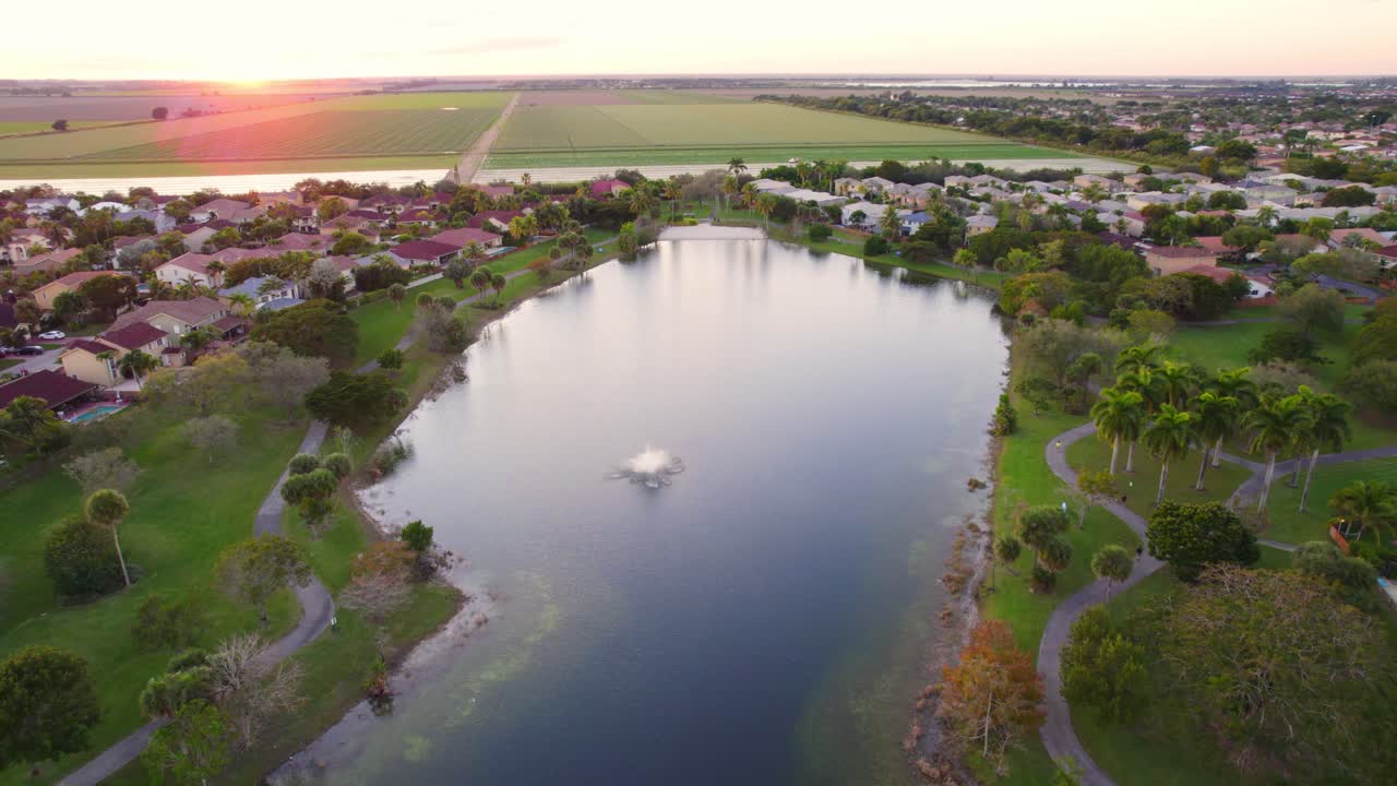 해가 지는 동안 마이애미 교외 이웃 호수 녹색 나무
