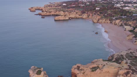 reveal shot of praia dos arrifes famous beach at the algarve portugal, aerial