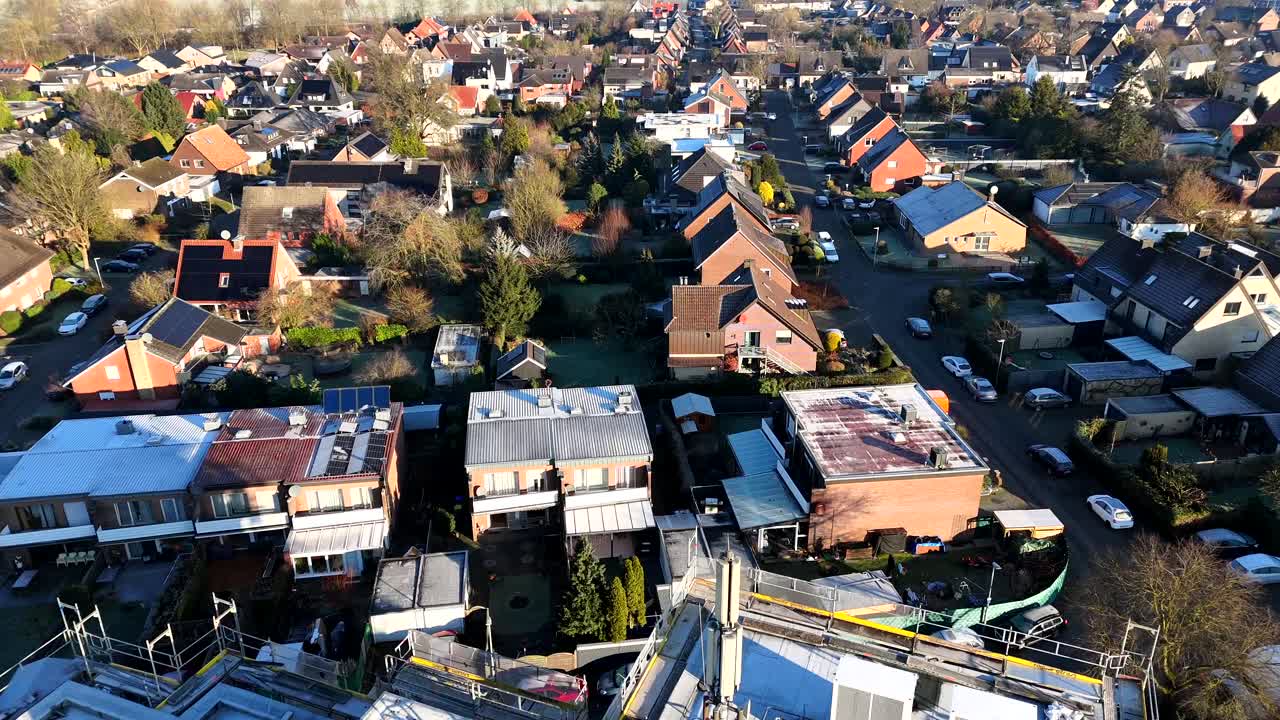 Pipe and antenna on top of new build residential tower during sunrise in german town. Cold winter day in small town. Construction site scene in City neighborhood.