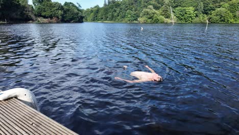 summer vacation activity young man swimming in river