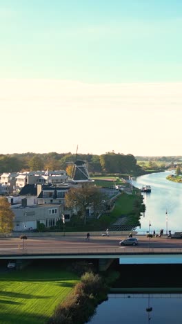 dutch town with river and windmill from above