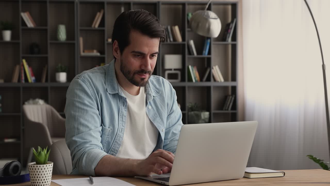 Man read e-mail on laptop feels happy by good news