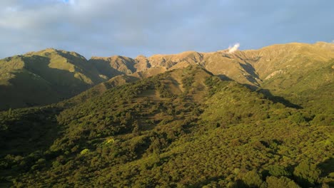 stunning aerial drone footage capturing lush vegetation, mesmerizing cloud and mountain landscapes in the last light of sunset