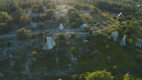 Aerial-shot-over-a-collection-of-limestone-rauks-on-Gotland,-Sweden