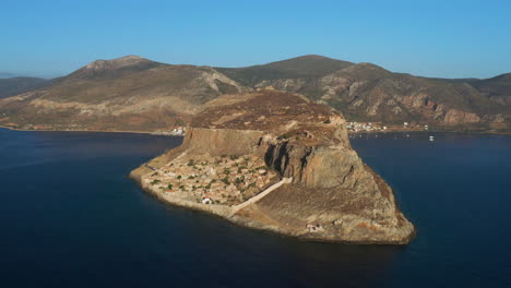 panorama of monemvasia old town in peloponnese peninsula surrounded by calm waters of ocean in greece