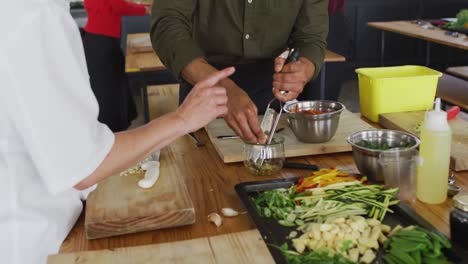 caucasian female chef teaching diverse group