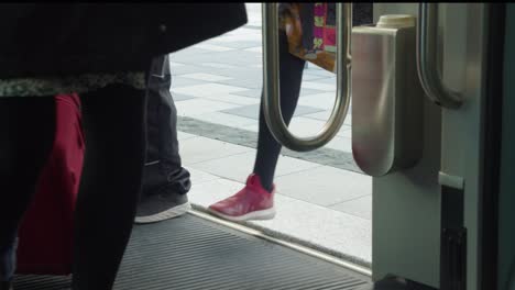 people board modern clean public transit commuter train, low angle