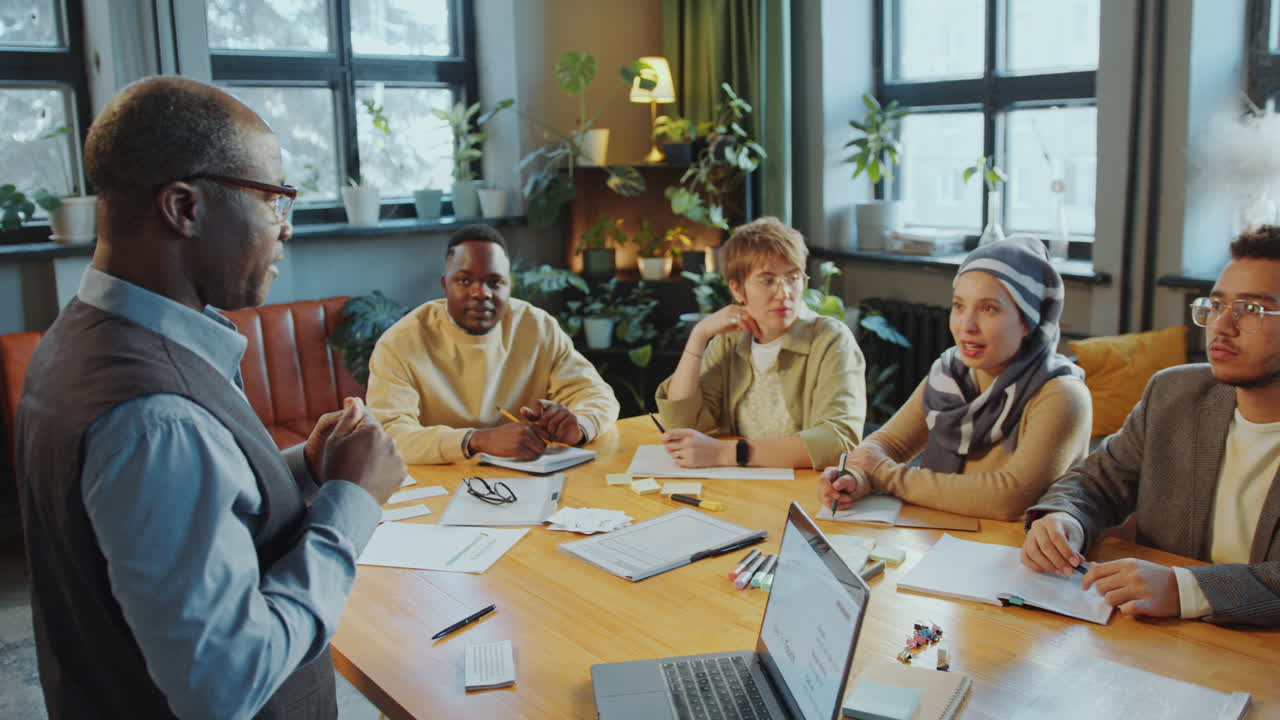 Teacher Explaining Material to Immigrant Students on Lesson in Language School
