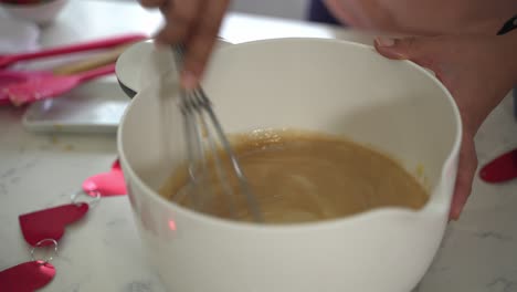 Whisking-a-bowl-of-batter-into-white-bowl-making-a-special-valentine's-day-cake-vegan-chocolate-cake-eggless-plant-based-dairy-free