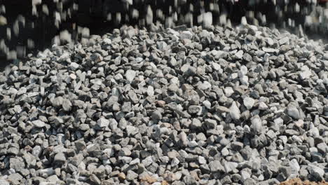 crushed stone crumbles to the ground from the truck body delivery of building materials  4k video